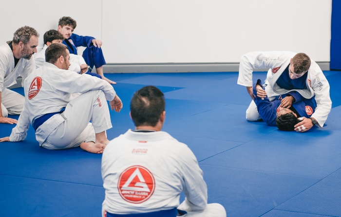 Two adults live-rolling in Brazilian Jiu-Jitsu at Gracie Barra Manotick